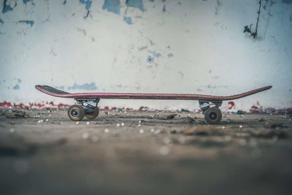 black skateboard near white wall