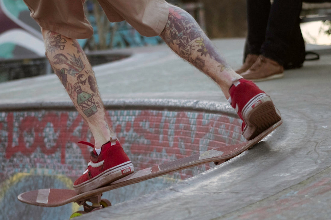 person in red nike sneakers riding skateboard