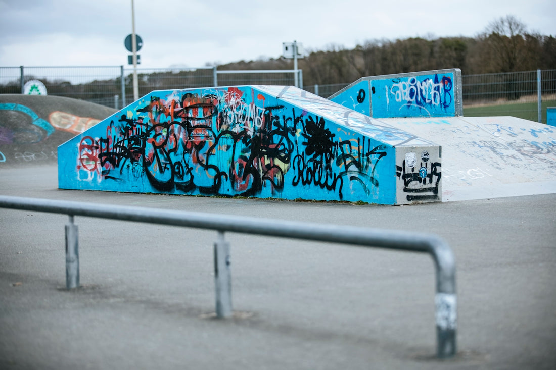 a skateboard park with graffiti on the walls