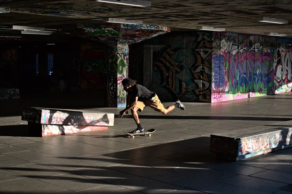 a man riding a skateboard on top of a sidewalk