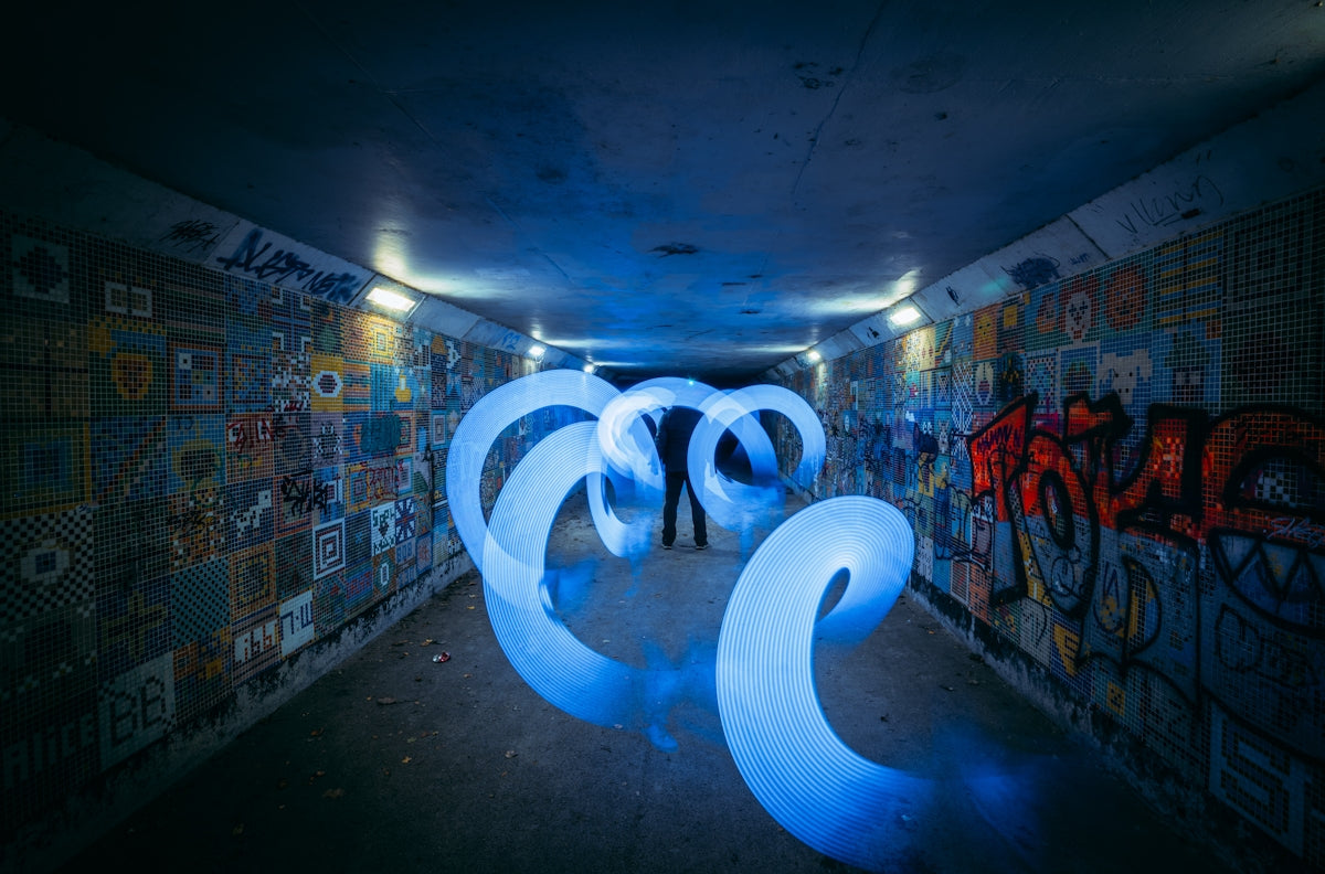 a couple of people standing in a room with graffiti on the walls