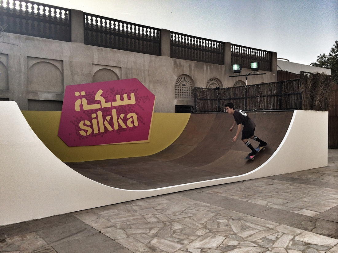 A man riding a skateboard up the side of a ramp