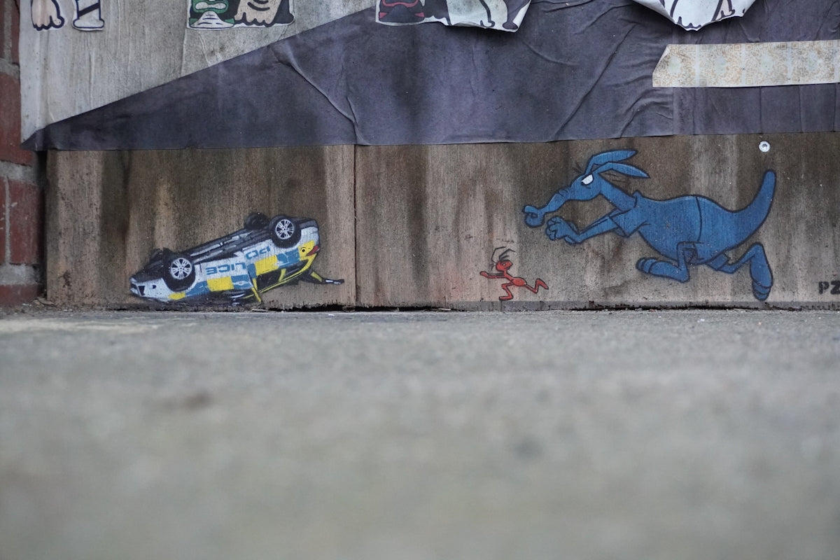 A wall with a painting of a dog on it